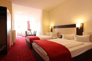 Postel nebo postele na pokoji v ubytování Adesso Hotel Kassel -pay at property on arrival- Ihr Automatenhotel in Kassel