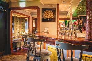 a bar with a row of chairs in a restaurant at Barr Na Sraide Inn in Dingle