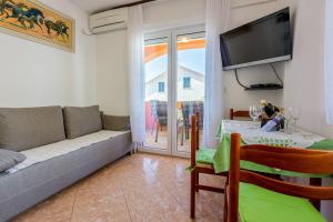 a living room with a couch and a table at Apartments Marissimo in Crikvenica