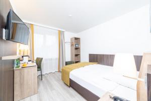 Ένα ή περισσότερα κρεβάτια σε δωμάτιο στο Hotel Alfa