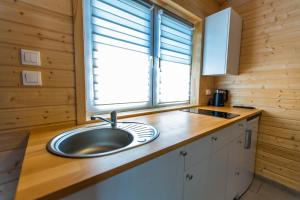 a kitchen with a sink and a window at Quiet Resort in Mielenko