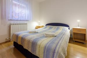 Posteľ alebo postele v izbe v ubytovaní Apartments Marissimo