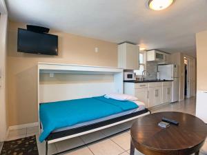 a bedroom with a bed and a table in it at Siesta Key Beach - Bari 665 #2 in Siesta Key