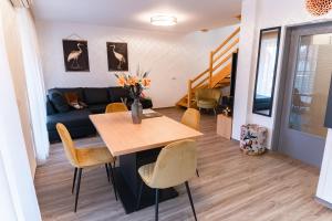 a living room with a table and a couch at Bella Mura Golden Apartment in Moravske Toplice