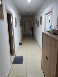 a hallway with a white tile floor in a room at Rooms Lagat in Troyan