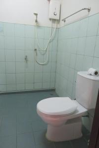 a bathroom with a toilet and a shower at Manora Garden in Phangnga