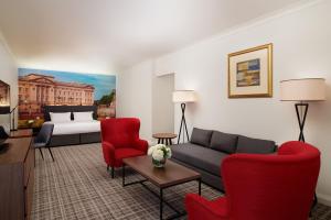 a living room filled with furniture and a couch at Millennium Gloucester Hotel London in London