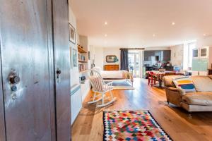 a living room with a couch and a chair at T's at Lower Rudloe Farm in Corsham