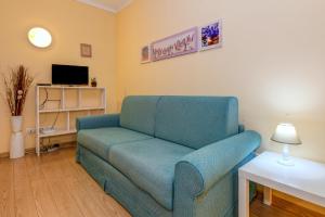 a living room with a blue couch and a table at Colleincanto Appartamento Mercedes in Gavardo