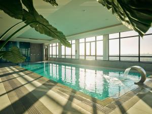 a swimming pool with a view of the ocean at Van der Valk Hotel Den Haag in Nootdorp