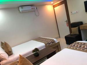 A bed or beds in a room at Yara Hotel
