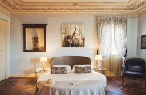 a bedroom with a bed with two pillows on it at Villa Fontana Relais Suite & Spa in Agliano Terme