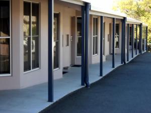 a row of blue poles in front of a building at Mackellar Motel in Gunnedah