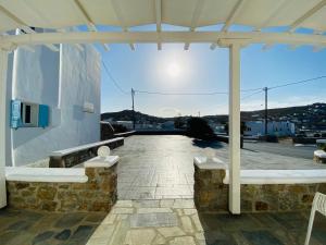 a pavilion with a view of a building at Eleftheria Hotel & Apartments in Ornos