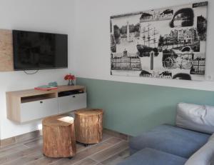 sala de estar con sofá y 2 taburetes de madera en 't Grüne Huysje, en Otterlo