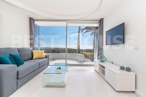a living room with a couch and a table at Stunning Bungalow at the Sand Dunes of Maspalomas in Playa del Ingles