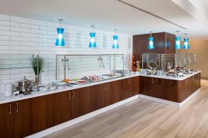 a large kitchen with wooden cabinets and blue lights at Crowne Plaza Atlanta Midtown, an IHG Hotel in Atlanta