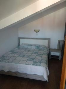 1 dormitorio con 1 cama con edredón en Апартамент в апарт хотел Forest Nook- Пампорово, en Pamporovo