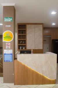 a kitchen with a counter top in a room at Pousada Center in Piratuba