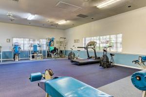 a gym with several treadmills and exercise bikes at Buddy's Place at the Beach in New Smyrna Beach