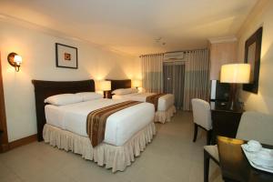 Ένα ή περισσότερα κρεβάτια σε δωμάτιο στο Crown Regency Suites Mactan