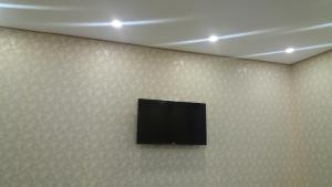 a flat screen tv hanging on a wall at Будинок для гостей по вул. Шевченка in Berehove