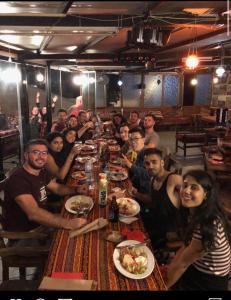 a group of people sitting at a long table eating food at Bahaus Guesthouse Hostel in Istanbul