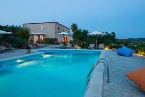 a swimming pool with a house and a building at Agroturisme Can Planells in San Miguel de Balansat