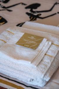 a stack of towels sitting on top of a table at Apartment Africa in Belgrade
