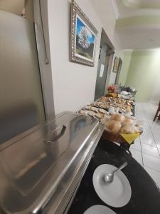 a buffet line with a bunch of donuts on display at Ipê Guaru Hotel in Guarulhos