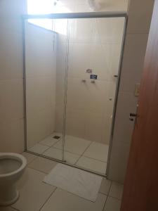 a shower with a glass door in a bathroom at Hotel Parati 