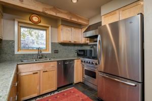 a kitchen with a stainless steel refrigerator and a window at Prospector 134 in Ketchum