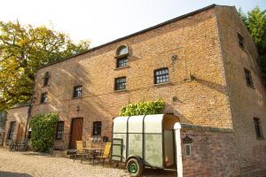 an old trailer parked in front of a brick building at The Carriage House, Studio 3A in Bilbrough