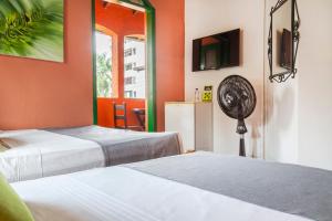 Ένα ή περισσότερα κρεβάτια σε δωμάτιο στο Ayenda Habana Vieja 1221