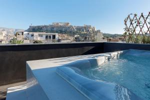 a swimming pool on the roof of a building at Athenian Lofts in Athens