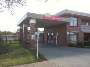 a brick building with a sign in front of it at Big Valley Lakeside Paradise Motor Inn in Shepparton