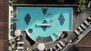 an overhead view of a swimming pool in a building at Hotel Hof Weissbad in Weissbad