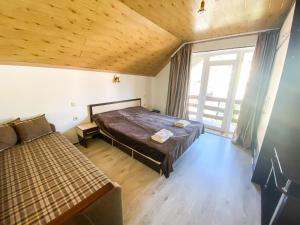 a bedroom with a large bed and a window at Veronika in Solochin