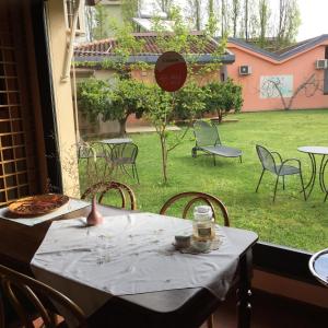 uma mesa e cadeiras com uma mesa e vista para um quintal em Gaia B&B em Castrovillari