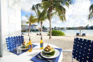 a table with a bowl of food and drinks on the beach at Sandyport Beach Resort in Nassau