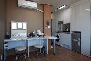 a kitchen with a table and two stools at YD Residence in Seoul