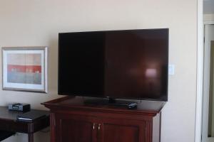 a flat screen tv sitting on top of a wooden stand at The Barrington Hotel in Halifax