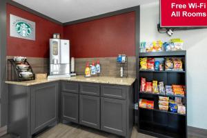 a free kitchen with a counter and a refrigerator at Red Roof Inn PLUS+ Huntsville in Huntsville