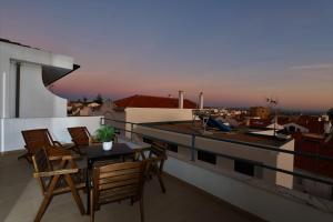 a balcony with a table and chairs on a roof at Castle in Blue Apartments-Sea View in Sines