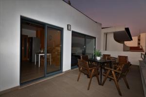 a dining room with a table and chairs at Castle in Blue Apartments-Sea View in Sines