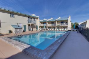a large swimming pool in front of a building at Gulf Winds #50 in Destin