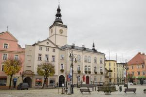 a building with a clock tower on top of it at Apartament Studio Klasztorna in Dzierżoniów