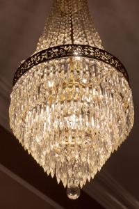 a large glass chandelier hanging from a ceiling at Belle Louise Historic Bed & Breakfast in Paducah