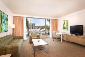 a living room with a couch and a television at DoubleTree by Hilton San Diego Bayside in San Diego