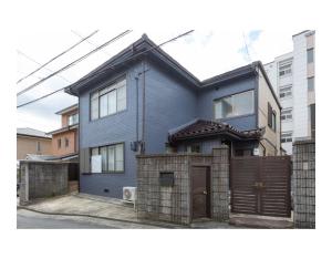 une maison bleue avec une clôture devant elle dans l'établissement Xu Zhai - Vacation STAY 03778v, à Kyoto